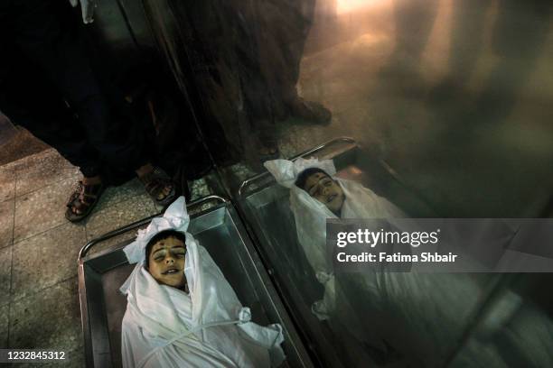 The body of the child Ali Nassar who was killed during an Israeli raid in central Gaza City on May 12, 2021 in Gaza City, Gaza. At least three dozen...