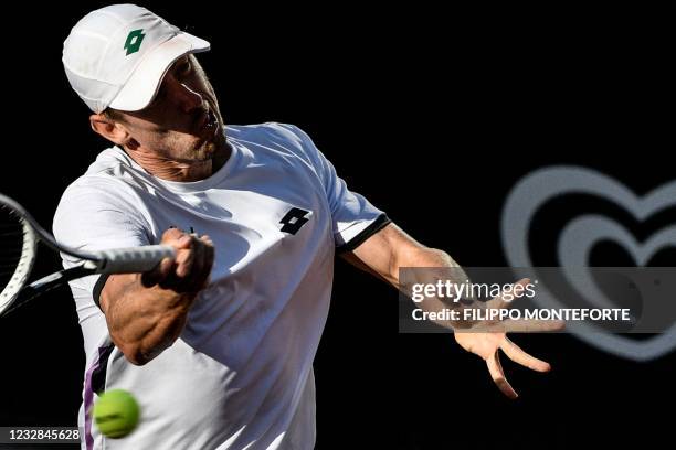 Australia's John Millman returns a shot to Italy's Matteo Berrettini during their match of the Men's Italian Open at Foro Italico on May 12, 2021 in...