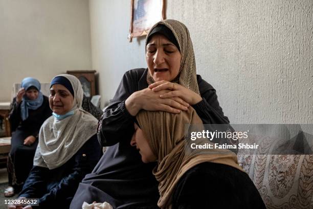 Relatives of Palestinian Abdul Salam Al-Ghazali, who was killed during an israeli raid in Al-Sabra neighborhood, central Gaza City, mourn during his...