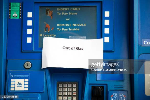 Notes are left on gas pumps to let motorists know the pumps are empty at an Exxon gas station in Charlotte, North Carolina on May 12, 2021. - Fears...