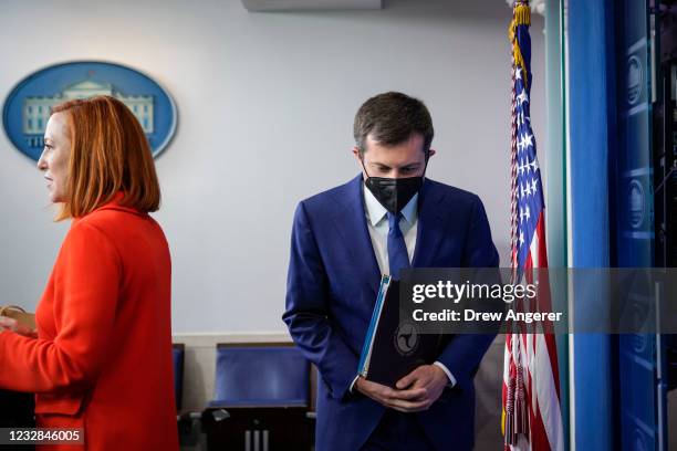 White House Press Secretary Jen Psaki and Secretary of Transportation Pete Buttigieg arrive for the daily press briefing at the White House on May...
