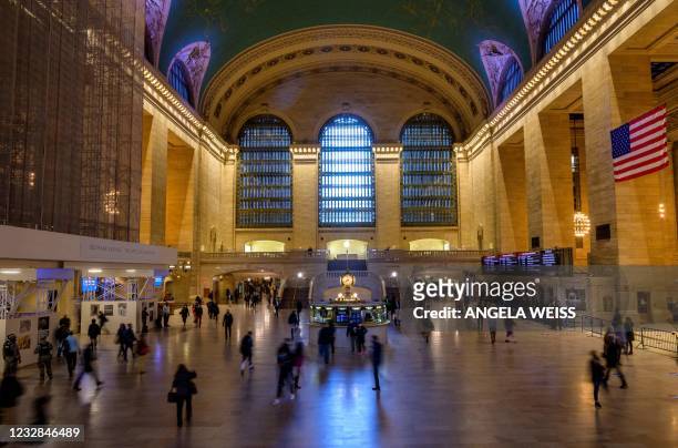 People commute through Grand Central Terminal train station on May 12, 2021 in New York City.