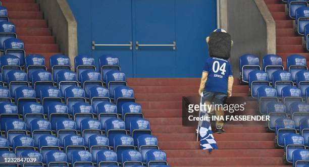 Schalke's mascot Erwin leaves the stands after the German first division Bundesliga football match FC Schalke 04 v Hertha Berlin on May 12, 2021 in...