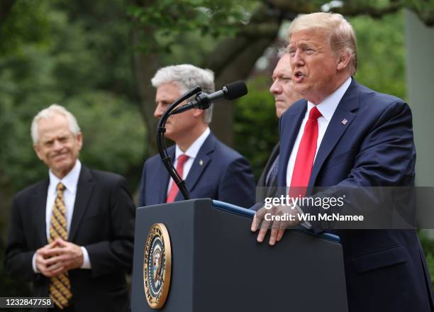 President Donald Trump is flanked by administration officials while speaking about U.S. Relations with China in the Rose Garden at the White House...