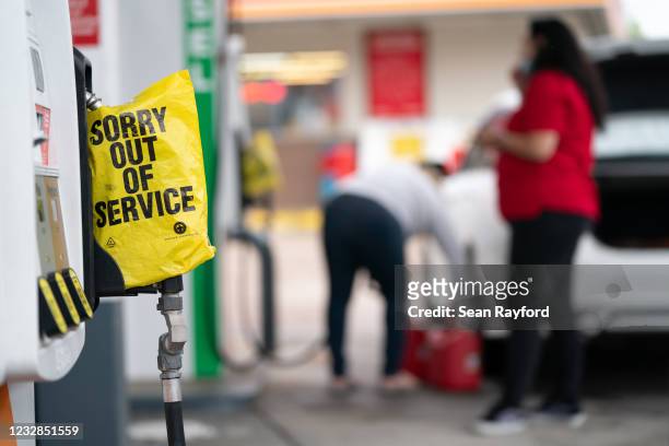An out of service bag covers a pump handle at a gas station May 12, 2021 in Fayetteville, North Carolina. Most stations in the area along I-95 are...