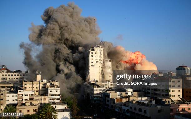 Smoke and flames rise from a tower building destroyed by Israeli air strikes amid a flare-up of Israeli-Palestinian violence in Gaza City Israel...