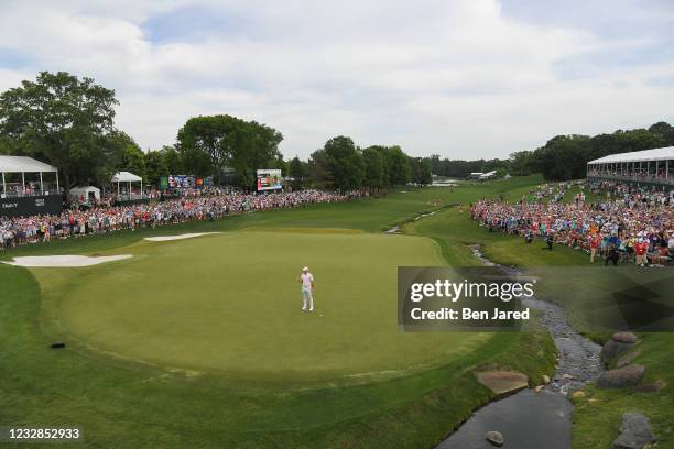 Rory McIlroy of Northern Ireland fist pumps on the 18th green while making the winning putt during the final round of the Wells Fargo Championship at...