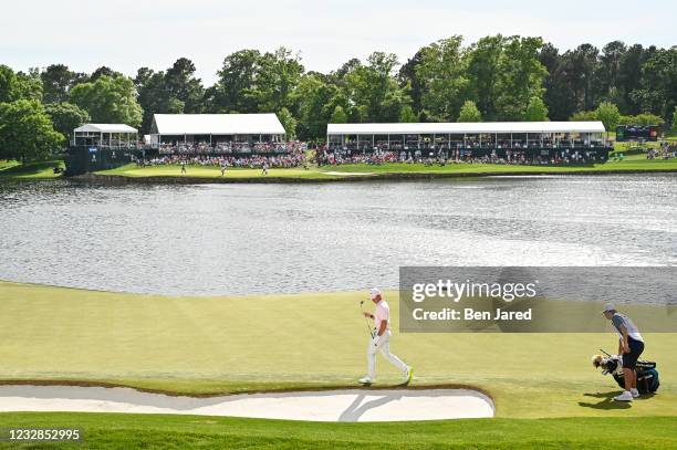 Rory McIlroy of Northern Ireland walks by the bunker on the 14th green during the final round of the Wells Fargo Championship at Quail Hollow Club on...