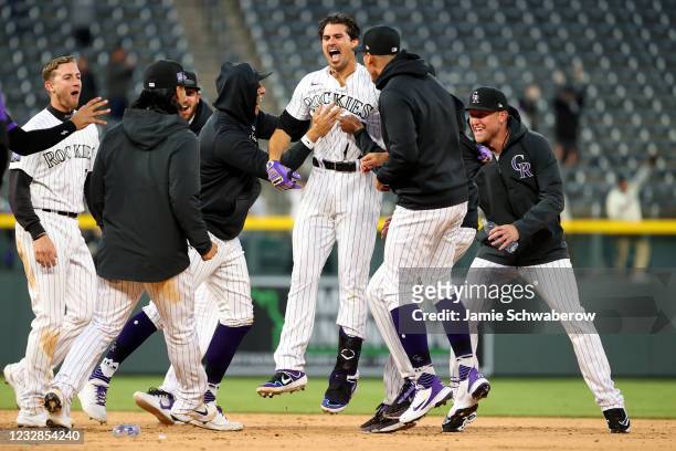 Josh Fuentes of the Colorado Rockies celebrates after hitting a walk-off single against the San Diego Padres during game two of a doubleheader at...
