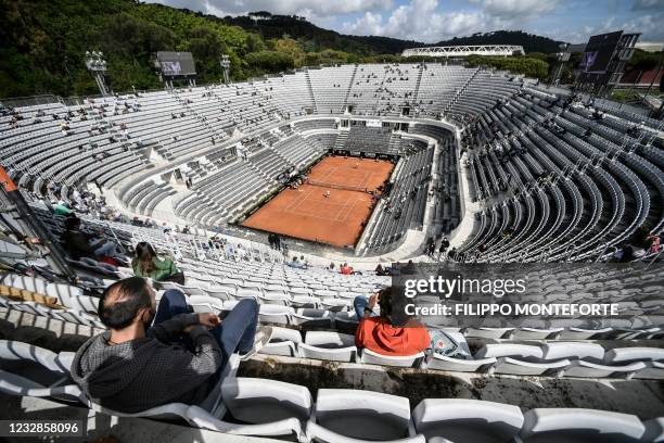 People watch the the eigh quarter tennis match Serbia's Novak Djokovic against Spain's Alejandro Davidovich on the central court during the Men's...