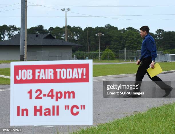 Man walks past a Job Fair Today sign outside during the 25th annual Central Florida Employment Council Job Fair at the Central Florida Fairgrounds....