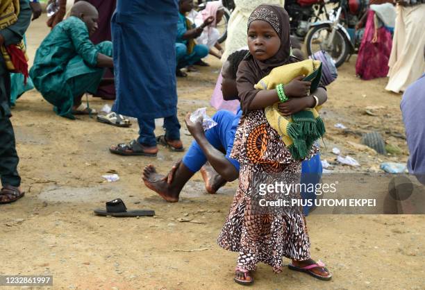 Young girl arrives with her mat to pray at Kara Isheri in Ogun State, southwest Nigeria, on May 13, 2021. - Muslim faithfuls across the country...