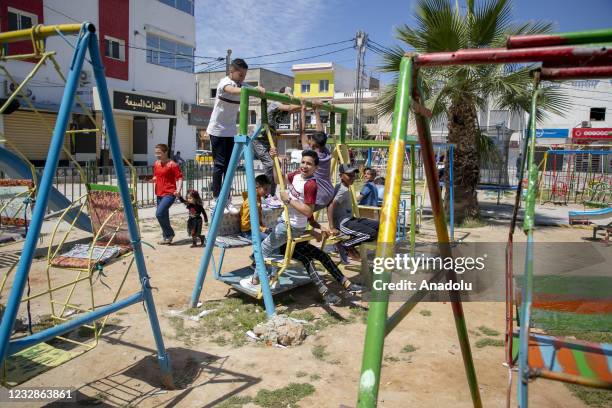 Tunisian children play on a playground as a celebration to mark the Eid al-Fitr amid the coronavirus pandemic in Tunis, Tunisia on May 13, 2021. Eid...