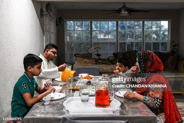Businessman Zeshan Sheikh , originally from Pakistan, with his two son Subhan Sheikh Amaan Sheikh and wife Sehar Sheikh break Ramadan fast at their...