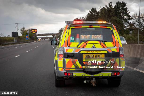 Highways England enforcement officer stops all traffic using a DO NOT PASS sign on the south bound lane of the M1 motorway somewhere near...