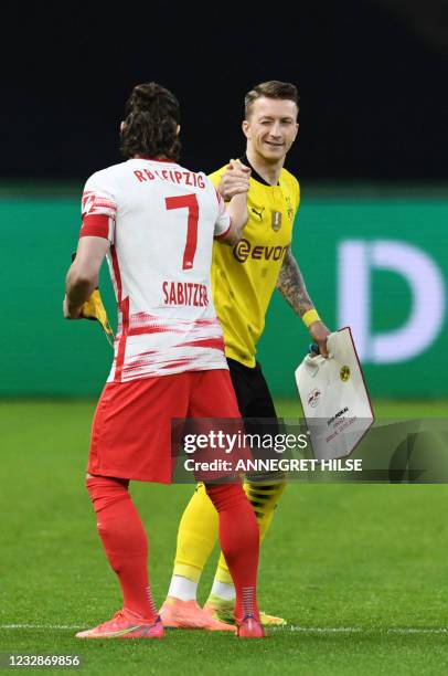 Leipzig's Austrian midfielder Marcel Sabitzer and Dortmund's German forward Marco Reus shake hands prior to the German Cup final football match RB...