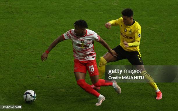 Leipzig's French midfielder Christopher Nkunku and Dortmund's English midfielder Jadon Sancho vie for the ball during the German Cup final football...