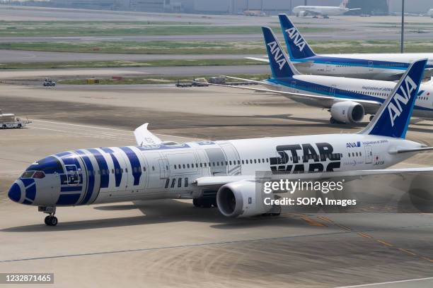 An ANA Boeing 787-9 Dreamliner painted to look like R2D2 from the Star Wars movies at Haneda international Airport.