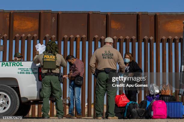 An asylum seeker from Colombia injects insulin after he turned himself in to US Border Patrol agents on May 13, 2021 in Yuma, Arizona. The Biden...