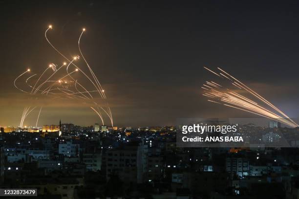 The Israeli Iron Dome missile defence system intercepts rockets fired by the Hamas movement towards southern Israel from Beit Lahia in the northern...