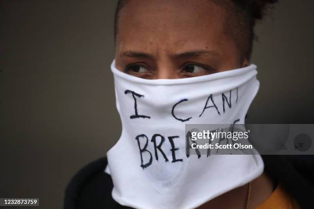 Person wears a mask that reads "I CAN'T BREATHE" as demonstrators continue to protest the death of George Floyd following a night of rioting on May...
