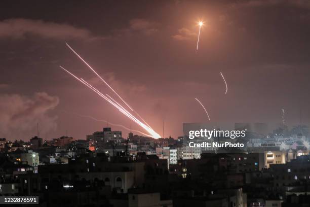 Rockets light up the night sky as they are fired towards Israel from Beit Lahia in the northern Gaza Strip on May 14, 2021. - Israel pounded Gaza and...