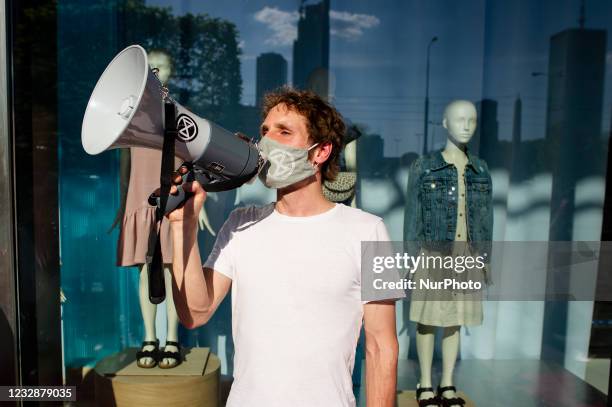 Climate activists gathered in front of one of Warsaw city center's shopping malls in a protest against ''fast fashion'' - rapidly changing trends,...