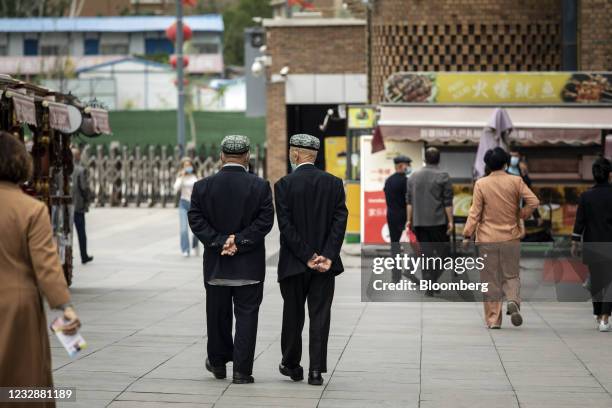 People walk through the Xinjiang International Grand Bazaar in Urumqi, Xinjiang province, China, on Wednesday, May 12, 2021. China has told nations...