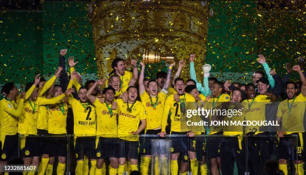 Dortmund's German forward Marco Reus lifts the trophy after the German Cup final football match RB Leipzig v BVB Borussia Dortmund, in Berlin on May...