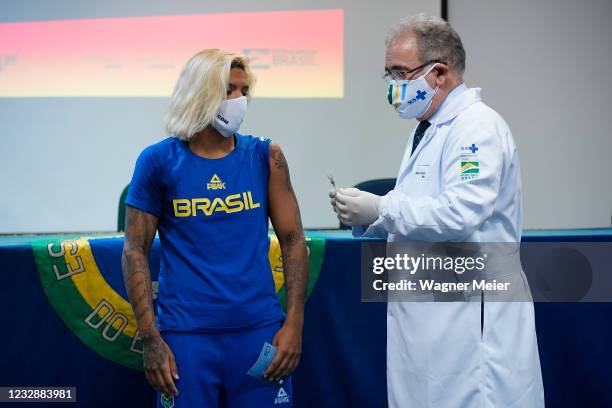 Brazilian athlete and marathon swimmer Ana Marcela Cunha from receives the first dose of Pfizer vaccine from Brazilian Health Minister Marcelo...