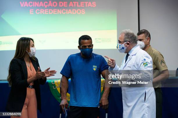 Brazilian athlete and rower Michel Pessanha receives the first dose of Pfizer vaccine from Brazilian Health Minister Marcelo Queiroga as part of the...