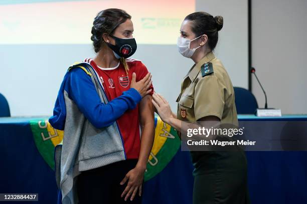 Brazilian athlete and swimmer Larissa de Oliveira from receives the first dose of Pfizer vaccine as part of the anti COVID-19 vaccination of...