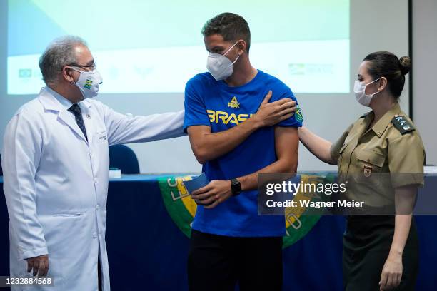 Brazilian athlete and archer Marcus Vinicius D Almeida talks to Brazilian Health Minister Marcelo Queiroga after receiving the first dose of Pfizer...