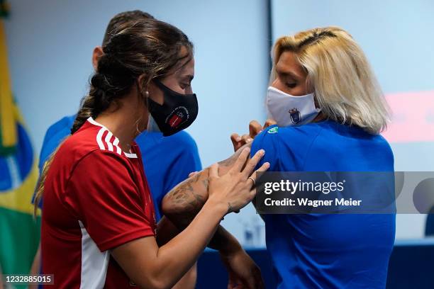 Brazilian athletes Ana Marcela Cunha, Marcus Vinícius D Almeida and Larissa de Oliveira talk after receiving their first dose of Pfizer vaccine as...