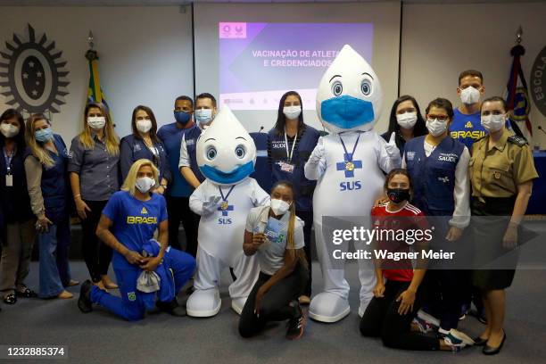 Brazilian athletes pose with health workers after receiving the first dose of Pfizer vaccine as part of the anti COVID-19 vaccination of Brazilian...