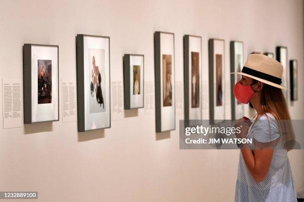 Tourist looks at art during the reopening of the Smithsonian National Portrait Gallery in Washington, DC, on May 14, 2021.