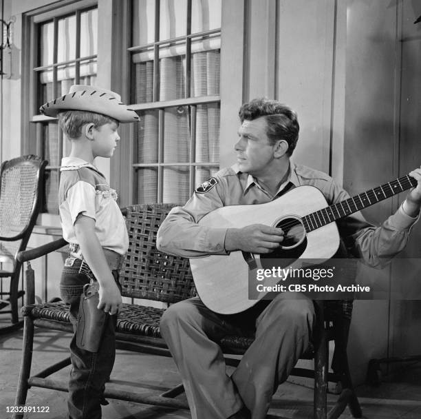 Andy Griffith plays the guitar for his son Opie, played by Ron Howard, in 'The Runaway KId' episode of the CBS television series "The Andy Griffith...