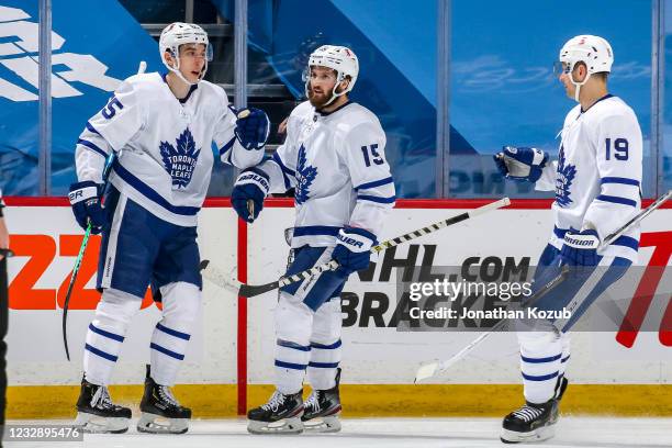 Ilya Mikheyev, Alexander Kerfoot and Jason Spezza of the Toronto Maple Leafs celebrate a second period goal against the Winnipeg Jets at the Bell MTS...