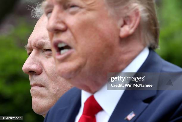 Secretary of State Mike Pompeo listens as U.S. President Donald Trump speaks about U.S. Relations with China, at the White House May 29, 2020 in...