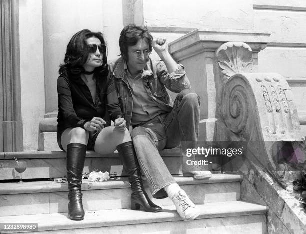 Music legend John Lennon and his wife Yoko Ono pose for photographers in Cannes 17 May 1971 where they presented their movies 'Apotheosis' and 'The...