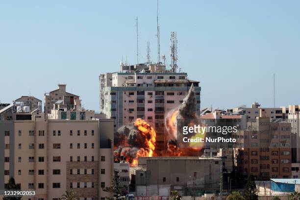 Ball of fire erupts from the Jala Tower as it is destroyed in an Israeli airstrike in Gaza city controlled by the Palestinian Hamas movement, on May...