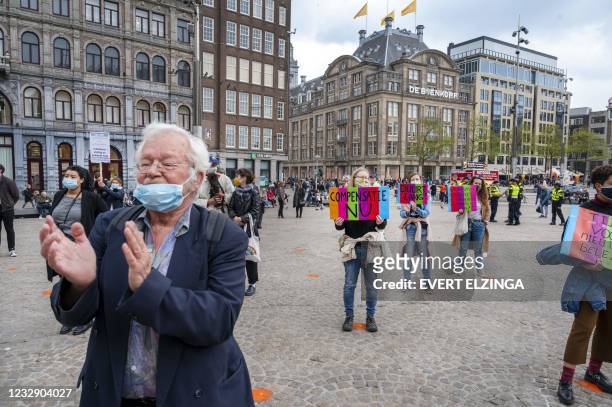 People take part in a protest to denounce a scandal in which tax officials wrongly accused thousands of parents of fraud, on the Dam in Amsterdam,on...