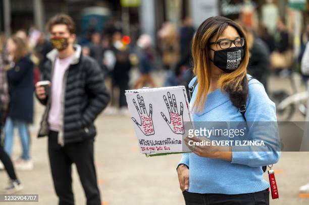 People take part in a protest to denounce a scandal in which tax officials wrongly accused thousands of parents of fraud, on the Dam in Amsterdam,on...