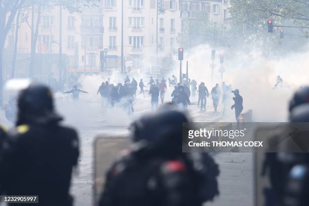 Protesters, surrounded by tear gas, face French riot mobile gendarmes during a demonstration in solidarity with the Palestinians called over the...