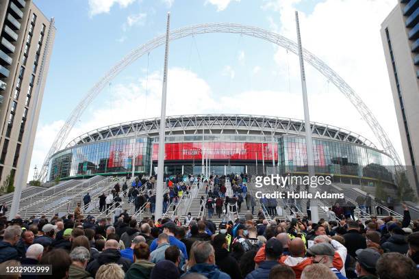 Football fans arrive at Wembley Stadium ahead of the FA Cup final on May 15, 2021 in London, England. A limited number of around 21,000 fans, subject...