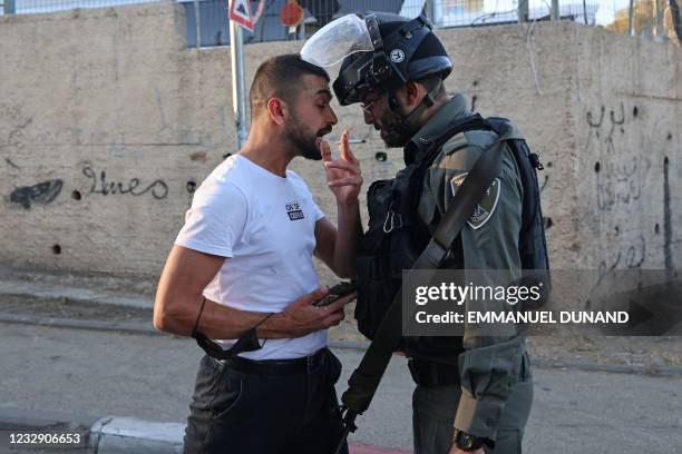 Palestinian argues with a member of Israeli security forces in the east Jerusalem neighbourhood of Sheikh Jarrah, where looming evictions of...