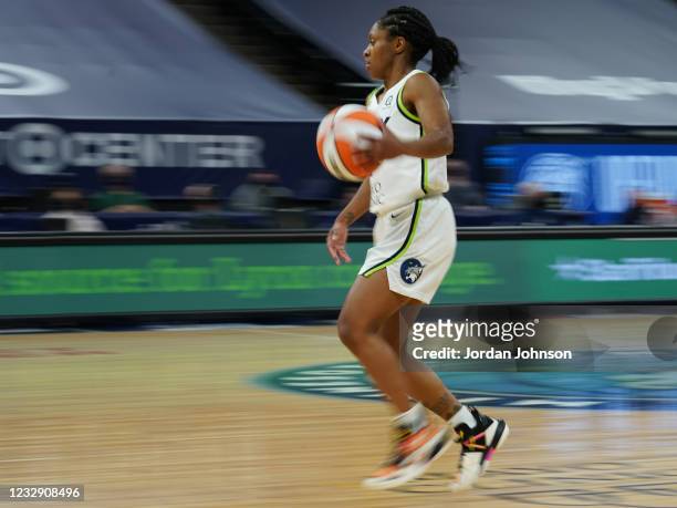 Crystal Dangerfield of the Minnesota Lynx brings the ball up court against the Phoenix Mercury on May 14, 2021 at Target Center in Minneapolis,...