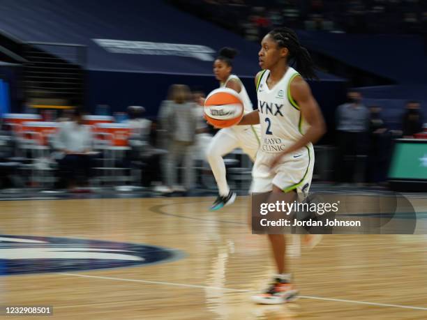 Crystal Dangerfield of the Minnesota Lynx brings the ball up court against the Phoenix Mercury on May 14, 2021 at Target Center in Minneapolis,...