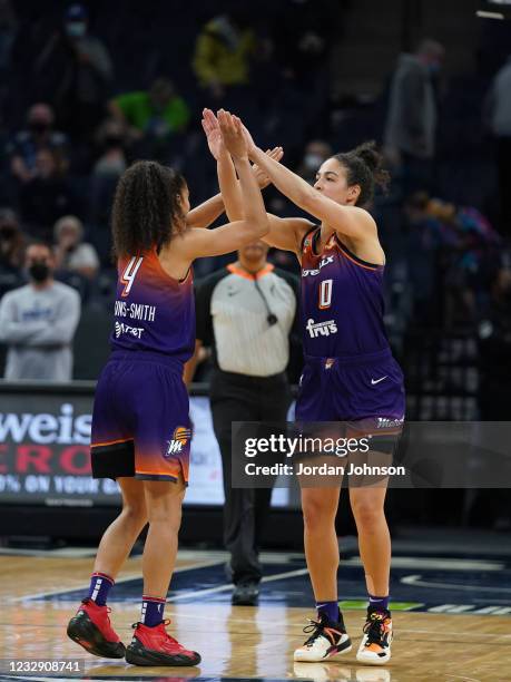 Kia Nurse of the Phoenix Mercury high fives Skylar Diggins-Smith during the game against the Minnesota Lynx on May 14, 2021 at Target Center in...