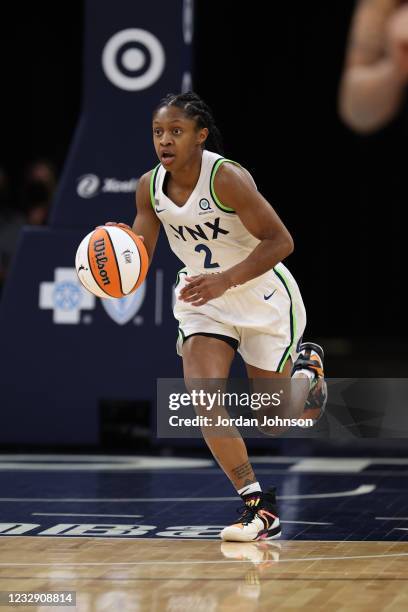 Crystal Dangerfield of the Minnesota Lynx brings the ball up court against the Phoenix Mercury on May 14, 2021 at Target Center in Minneapolis,...